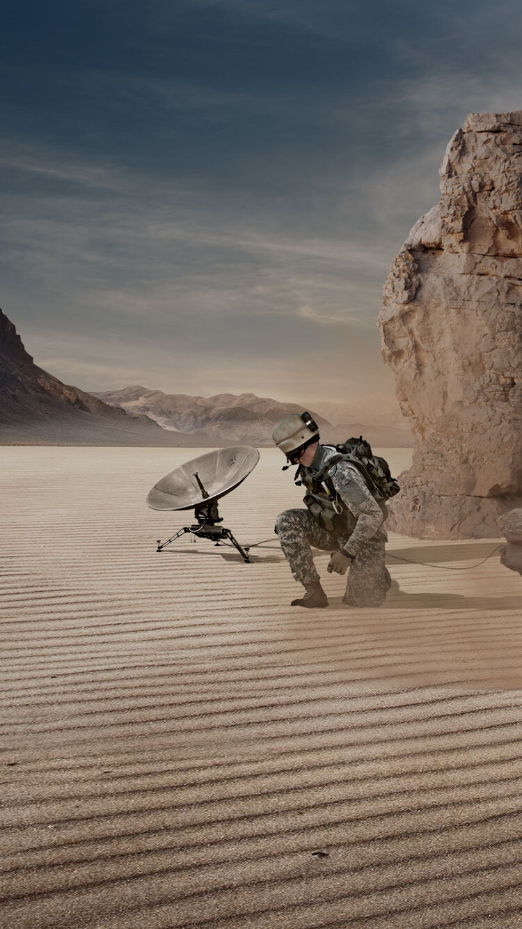 soldier in a desert with a satellite dish