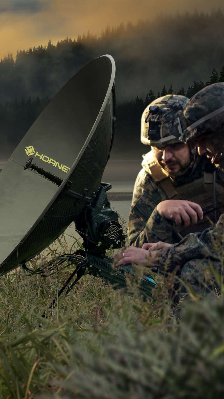 two soldiers at a laptop